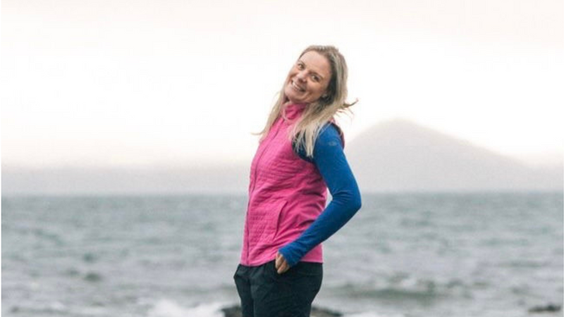 women in pink vest smiling