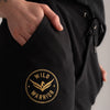 Wild Warrior joggers with close up view of badge logo, hand in pocket.