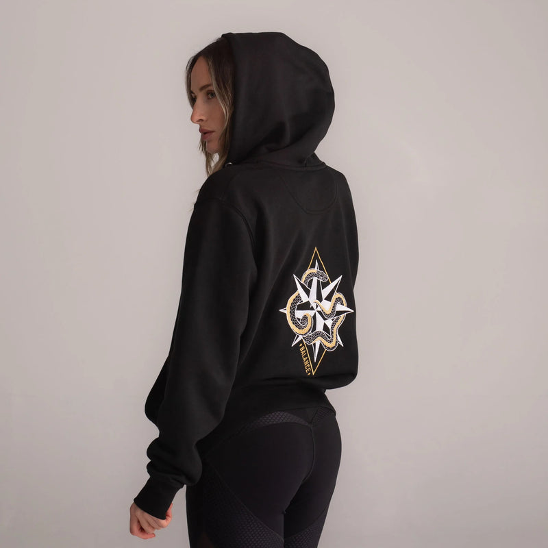 Wild Warrior Woman wearing black leggings and balance black zip up hoodie with snake and compass embroidery