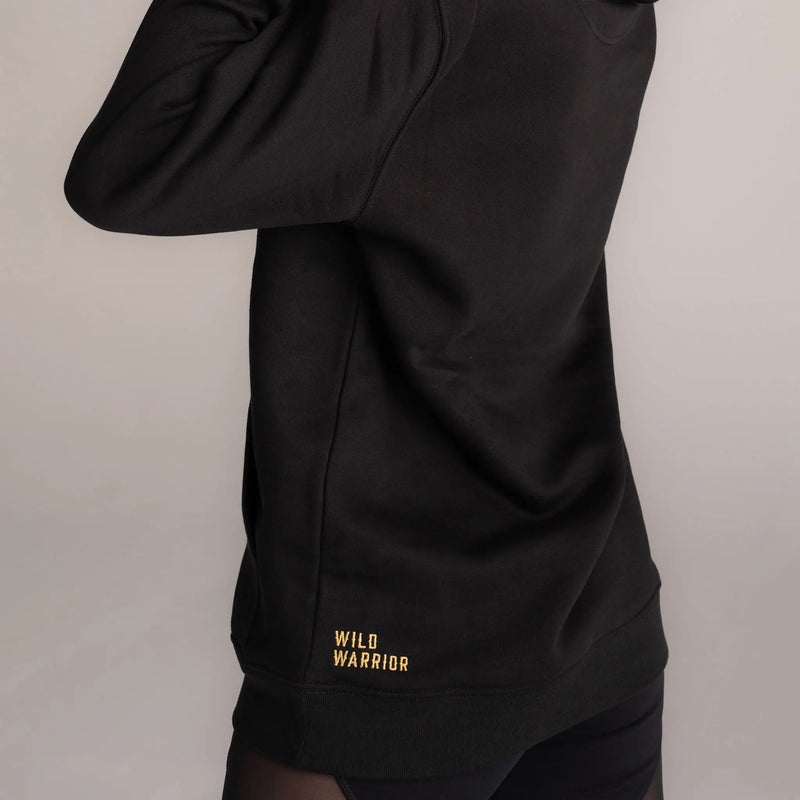 Wild warrior logo words embroidered in gold on bottom of black hoodie